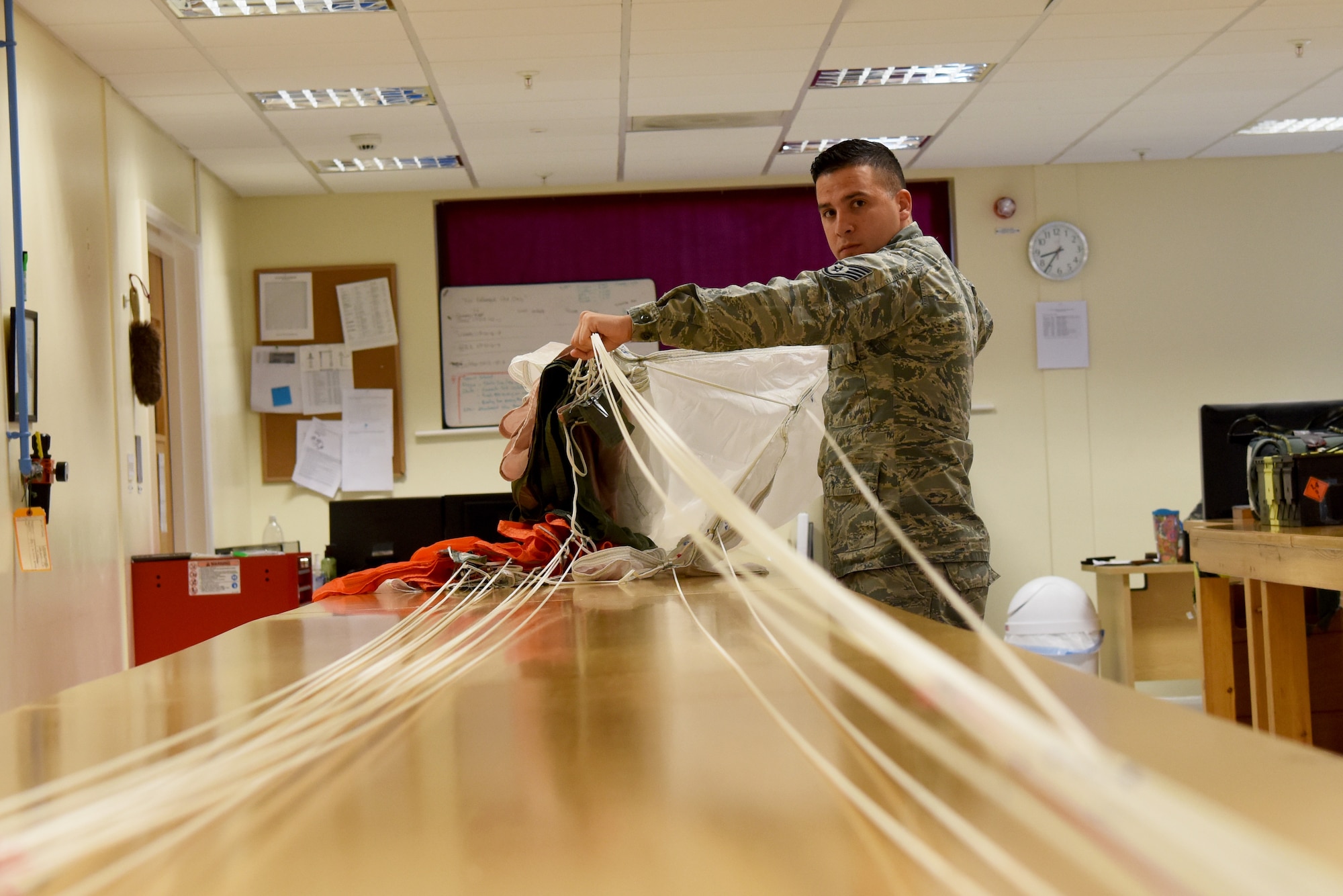 Staff Sgt. Anthony Silva, 48th Operation Support Squadron Aircrew Flight Equipment supervisor, checks to ensure the lines on a parachute are not tangled at Royal Air Force Lakenheath, England, Sept. 13, 2018. Every unique piece of gear, from G-Suits to helmets, communications and survival rations, is carefully maintained by Liberty Aircrew Flight Equipment Airmen, ensuring that aircrews are outfitted for any situation they may face in the air, land or sea. (U.S. Air Force photo/ Senior Airman John A. Crawford)