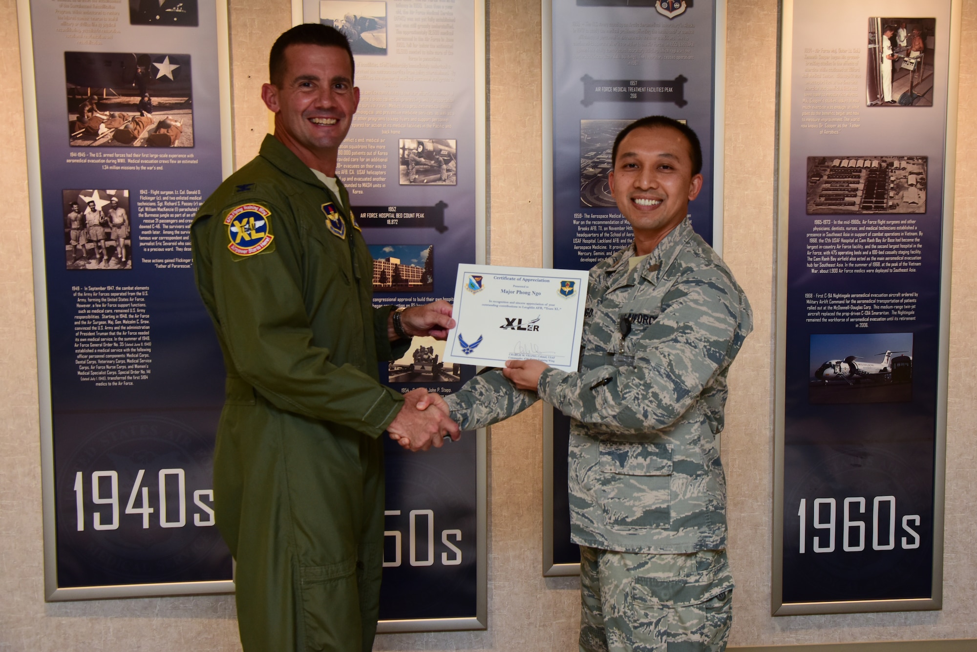 Maj. (Dr.) Phong Ngo, 47th Medical Operations Squadron physician, was chosen by wing leadership to be the “XLer” of the week, for the week of Sept. 10, 2018, at Laughlin Air Force Base, Texas. The “XLer” award, presented by Col. Charlie Velino, 47th Flying Training Wing commander, is given to those who consistently make outstanding contributions to their unit and the Laughlin mission. (U.S. Air Force photo by Airman 1st Class Marco A. Gomez)