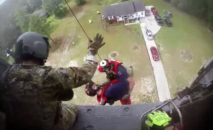 Pararescue Airmen Tech Sgt. Ryan Dush and Staff Sgt. Griffin Elzey, both members of the New York Air National Guard's 106th Rescue Wing, are lowered out of a HH-60 Pave Hawk helicopter assigned to the wing during a rescue mission in Lumberton, North Carolina, on Sept. 17, 2018. The two Airmen were descending to make an assessment of how many people were in the house, surrounded by flood waters and the best way to get them out. Eventually 15 people were rescued by two HH-60s, one flown by New York Air Guardsmen and the other by an aircrew from the California Air National Guard's 129th Rescue Wing.