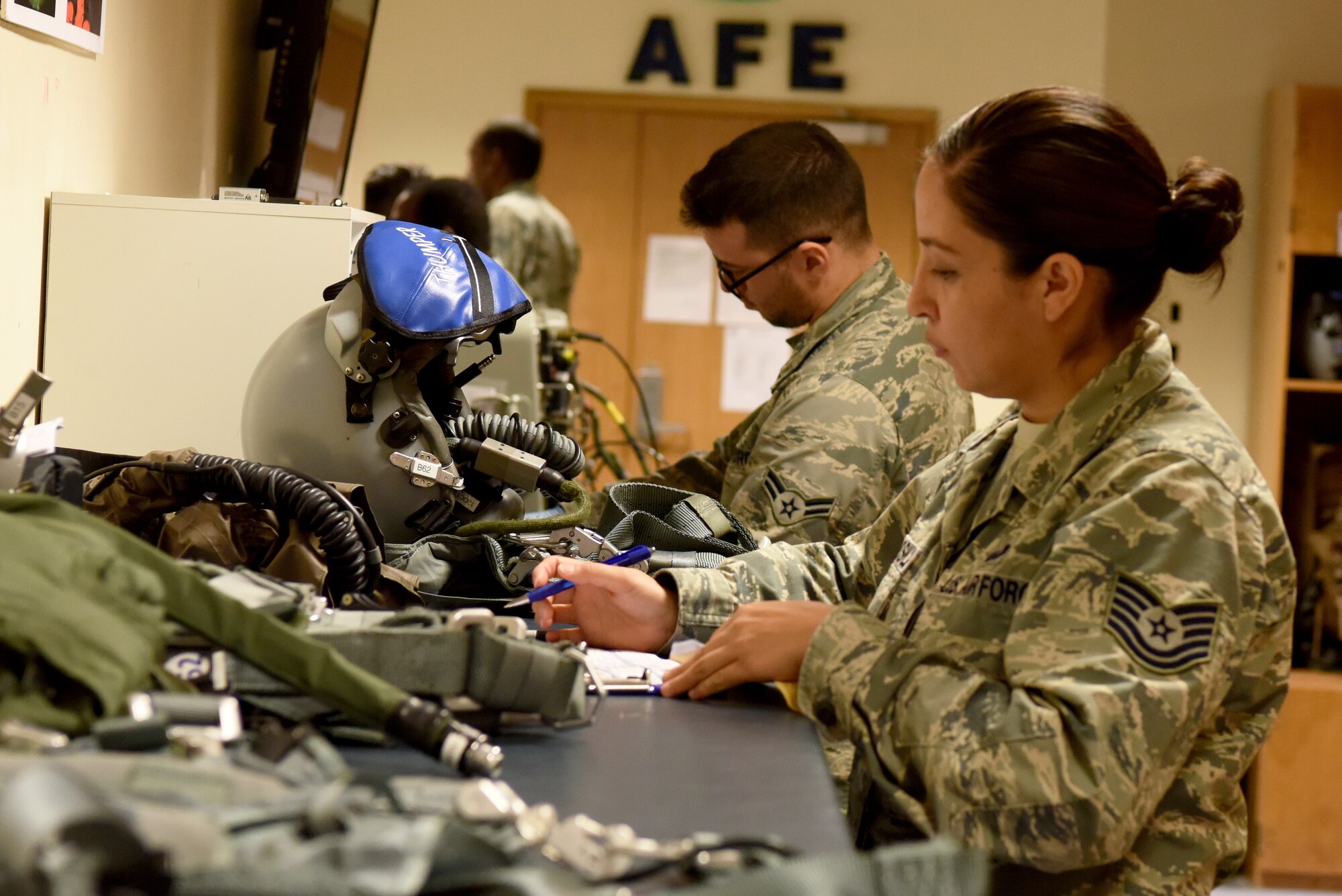 Airmen from the 48th Operation Support Squadron Aircrew Flight Equipment shop, prepare aircrew gear during a pre-flight/post-flight inspection at Royal Air Force Lakenheath, England, Sept. 13, 2018. Acute attention to detail by AFE technicians is essential to provide crews with the confidence they need to be able to operate. (U.S. Air Force photo/ Senior Airman John A. Crawford)