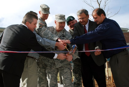 ​U.S. Air Force Maj. Gen. H. Michael Edwards (center), adjutant general of Colorado, cuts a ribbon commemorating the official opening of the Colorado Army National Guard's new Regional Training Institute and the Training Center Complex on Fort Carson, March 8, 2015. Joining Edwards in the ribbon-cutting are U.S. Army Col. Jesse Morehouse (center left), the 168th RTI commander, Army Col. Nicholas Goddard (center right), the COARNG construction and facilities management officer, and representatives from the four contracting companies that built the facilities. The two facilities are part of the Colorado National Guard's Centennial Training Site, and they offer more than 300,000 square feet of state-of-the-art training accommodations.