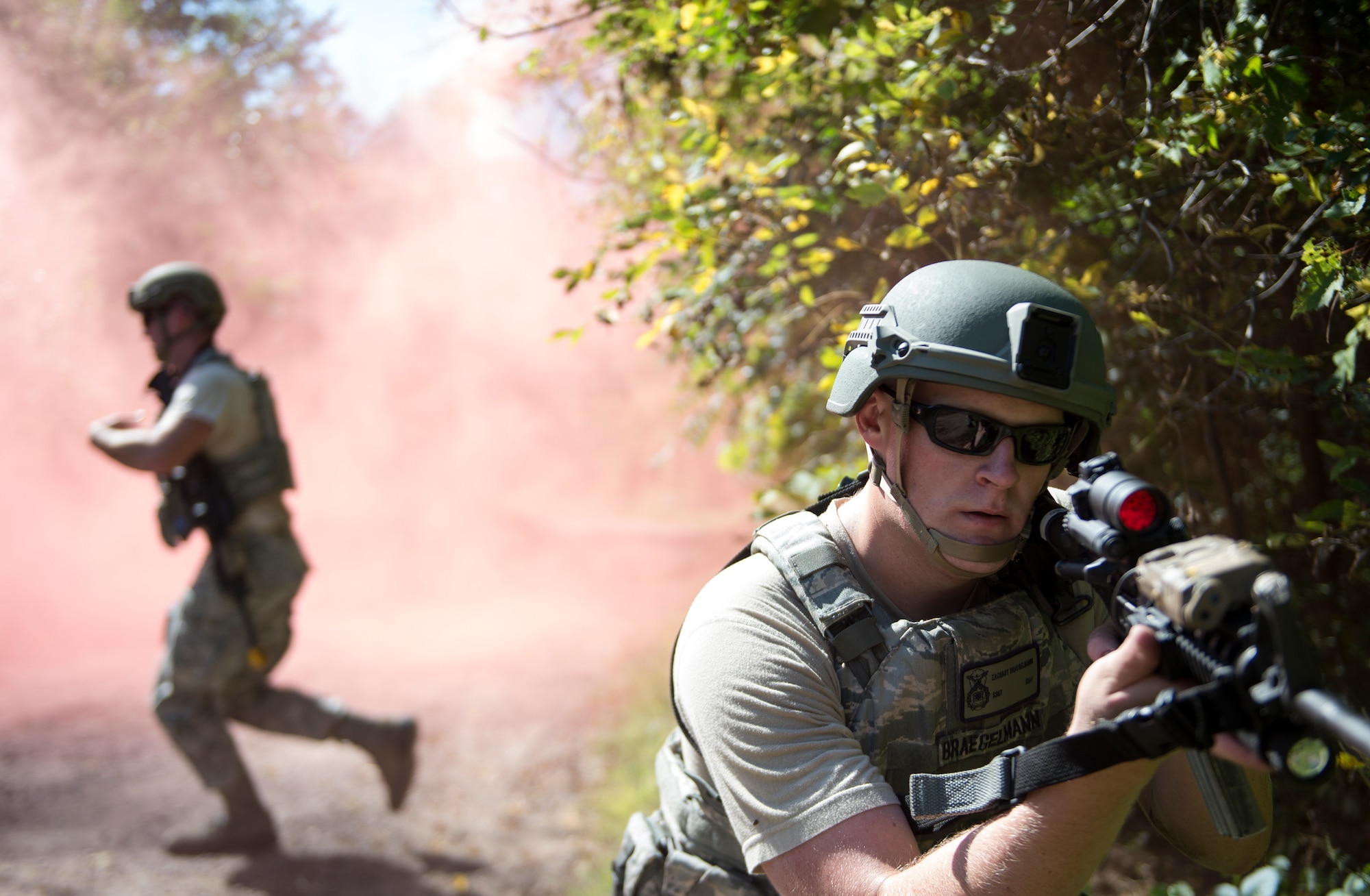 U.S. Air Force Staff Sgt. Zach Braegelmann, 133rd Security Forces Squadron, keeps a 360 degree perimeter as members cross the road at the Arden Hills Army Training Site, Arden Hills, Minn., Sept., 16, 2018.