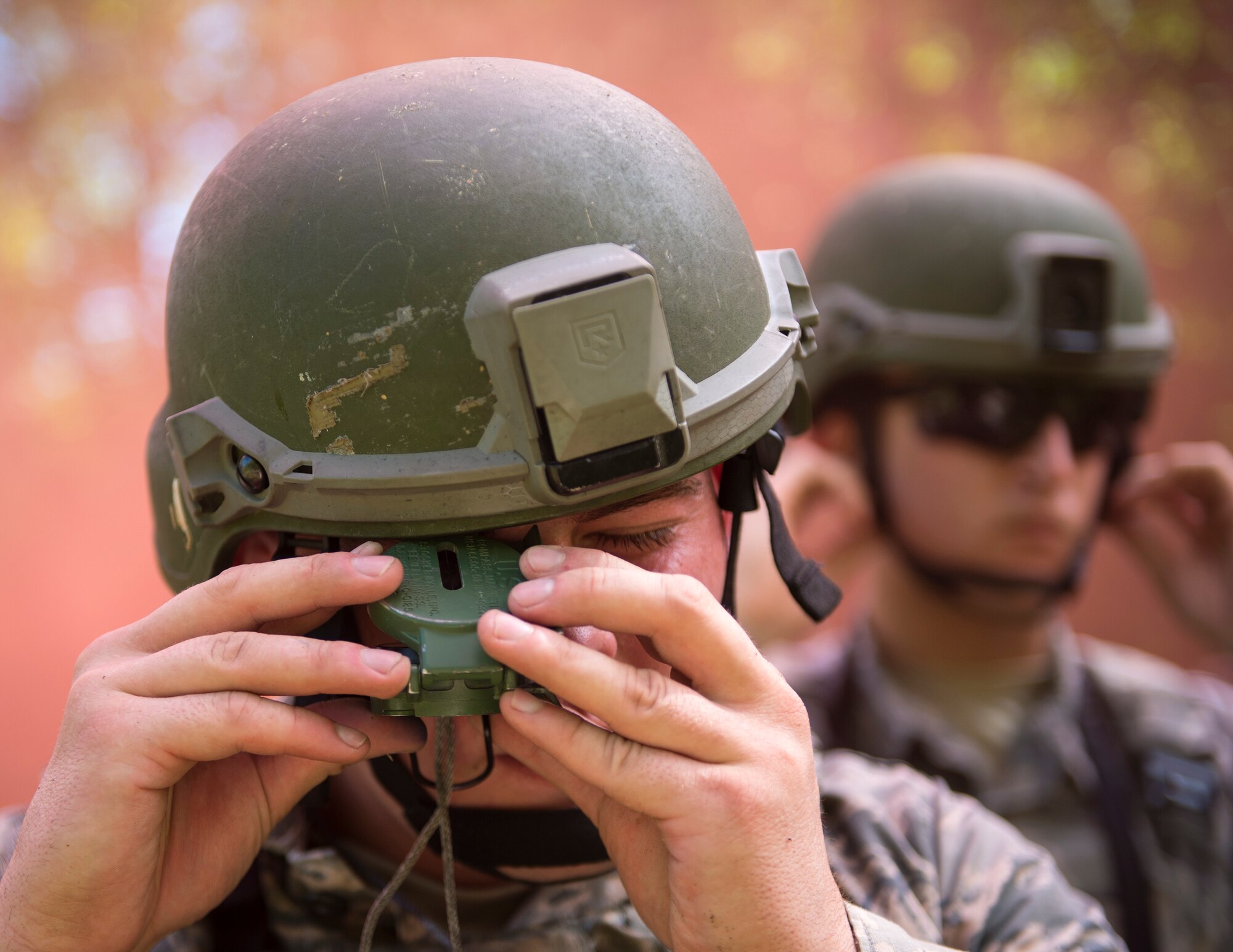 U.S. Air Force Airman 1st Class Christian Petersen, center, 133rd Security Forces Squadron, shoots an azimuth at the Arden Hills Army Training Site, Arden Hills, Minn., Sept., 16, 2018.