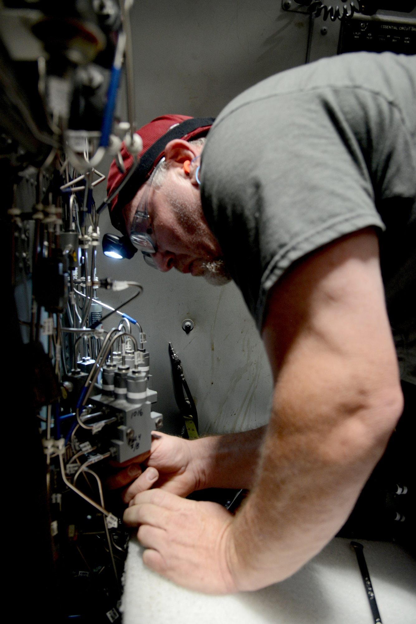 Rod Weeks, an aircraft ordnance mechanic, inspects panel 4 of the defensive system operator section of a B-1B Lancer.