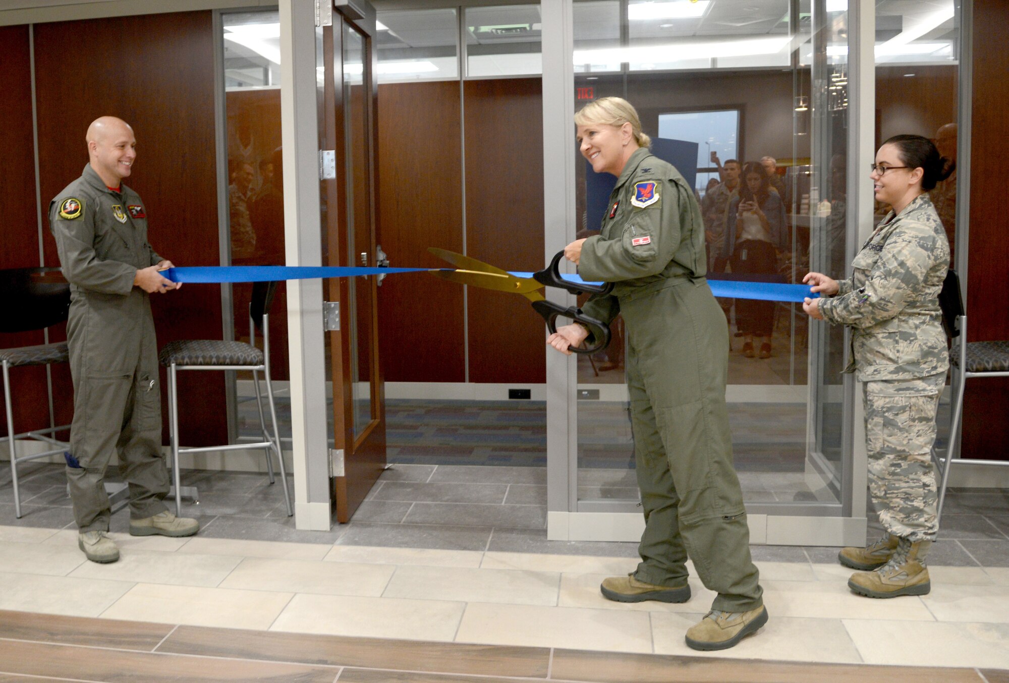 513th Air Control Group Commander Col. Laurie Dickson cuts the ceremonial ribbon inside Bldg. 461, the new home of the Thumpers. The 513th is a Reservist group which supports the 552nd Air Control Wing. The new 30,000 sq. ft. operations center will combine the 513ACG, the 513th Operations Support Flight (513OSS) and the 970th Airborne Air Control Squadron, after 20 years of being geographically separated on base.