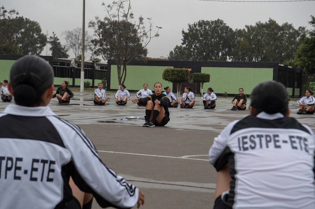 A U.S. Army Soldier conducts physical readiness training with female soldiers of the Peruvian Army Sept. 10, 2018, in Lima, Peru