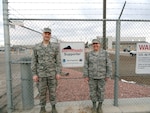 Air National Guard Col. Greg White, commander of the 233rd Space Group, and Tech. Sgt. Michelle Leonard, 233rd Space Group Emergency Manager, display the group's StormReady status at Greeley Air National Guard Station in Greeley, Colo., Jan. 23, 2013. (File photo)