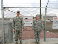 Air National Guard Col. Greg White, commander of the 233rd Space Group, and Tech. Sgt. Michelle Leonard, 233rd Space Group Emergency Manager, display the group's StormReady status at Greeley Air National Guard Station in Greeley, Colo., Jan. 23, 2013. (File photo)