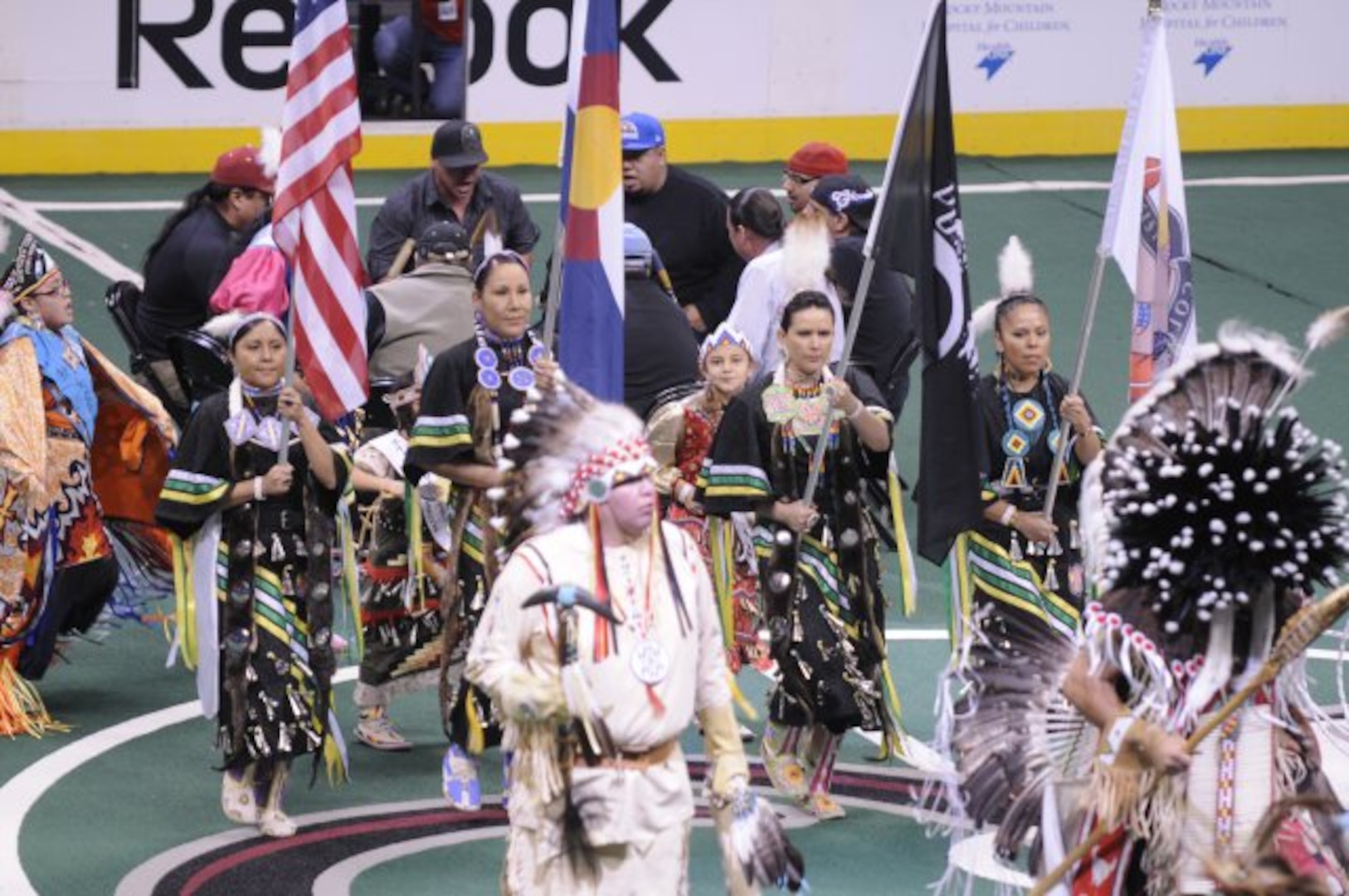 Members of the Sister Nations Color Guard, Colorado Army National Guard Staff Sgt. Cindy Littlefeather, Glenda Littlebird, Sgt. 1st Class Toni Eaglefeathers, and Carissa Gonzales, display the colors as part of a Native American presentation during halftime at a Colorado Mammoth versus Rochester Knight Hawks lacrosse game, March 2, 2012, at the Pepsi Center in Denver. The Sister Nations is a group of current and former Native American Soldiers who perform traditional dance and color guard. (Army National Guard photo by Capt. Michael Odgers/Released)