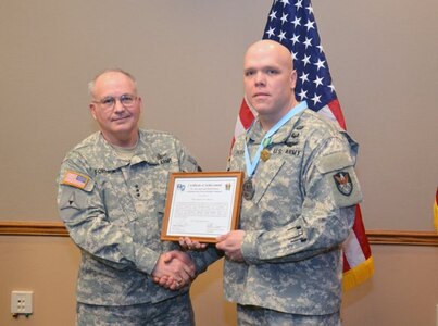 Lt. Gen. Richard P. Formica, commanding general, U.S. Army Space and Missile Defense Command/Army Forces Strategic Command, inducts Colorado Army National Guard Staff Sgt. Eugene A.K. Patton Jr., readiness noncommissioned officer, 117th Space Battalion, (1st Space Brigade), into the SMDC local chapter of the Sergeant Audie Murphy Club Feb. 27, 2013. (DOD photo by D.J. Montoya/Released)