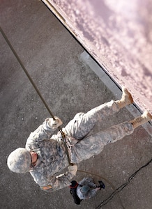 Sgt. Christopher Poquette, a multiple-launch rocket system crew member with the Colorado National Guard’s Battery A, 3rd Battalion, 157th Field Artillery, rappels from a building in a training village at Fort Carson, Colo., Feb. 2, 2013. Eight Soldiers with the Colorado Army National Guard competed in the Best Warrior Competition Feb. 2 and 3, which included both night and day land navigation as well as oral boards, firing both rifles and handguns, and performance in a simulated city designed to offer everything from rappelling to medical evacuation. (Official Army National Guard photo by Sgt. Brandy Simmons/Released)