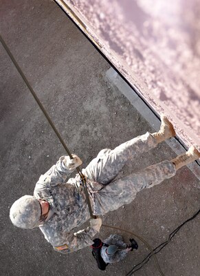 Sgt. Christopher Poquette, a multiple-launch rocket system crew member with the Colorado National Guard’s Battery A, 3rd Battalion, 157th Field Artillery, rappels from a building in a training village at Fort Carson, Colo., Feb. 2, 2013. Eight Soldiers with the Colorado Army National Guard competed in the Best Warrior Competition Feb. 2 and 3, which included both night and day land navigation as well as oral boards, firing both rifles and handguns, and performance in a simulated city designed to offer everything from rappelling to medical evacuation. (Official Army National Guard photo by Sgt. Brandy Simmons/Released)