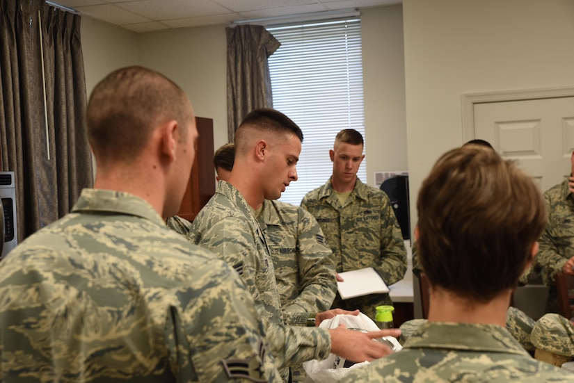 Air Force Senior Airman Daniel Eury Jr., center, speaks with his fellow Air Force Honor Guard members at Joint Base Anacostia-Bolling in Washington.