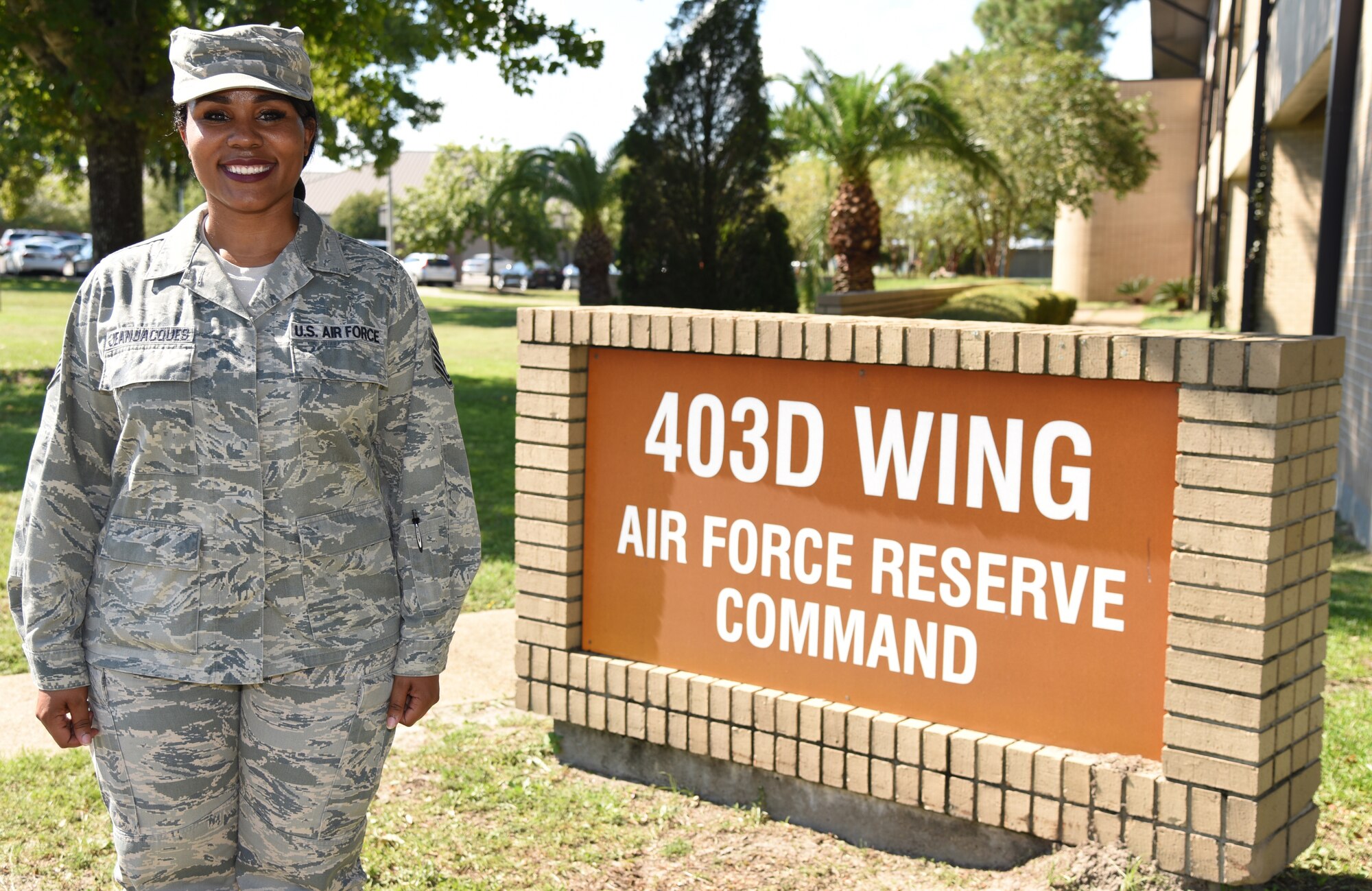 Tech Sgt. Dishau R. JeanJacques, a member of the 403d Force Support Squadron at Keesler Air Force Base, Miss., poses for a picture in front of the wing's headquarters September 19, 2018. JeanJacques was recently selected as the new coordinator for the Yellow Ribbon Reintegration Program for the 403rd Wing. (U.S. Air Force photo by Senior Airman Kristen L. Pittman).