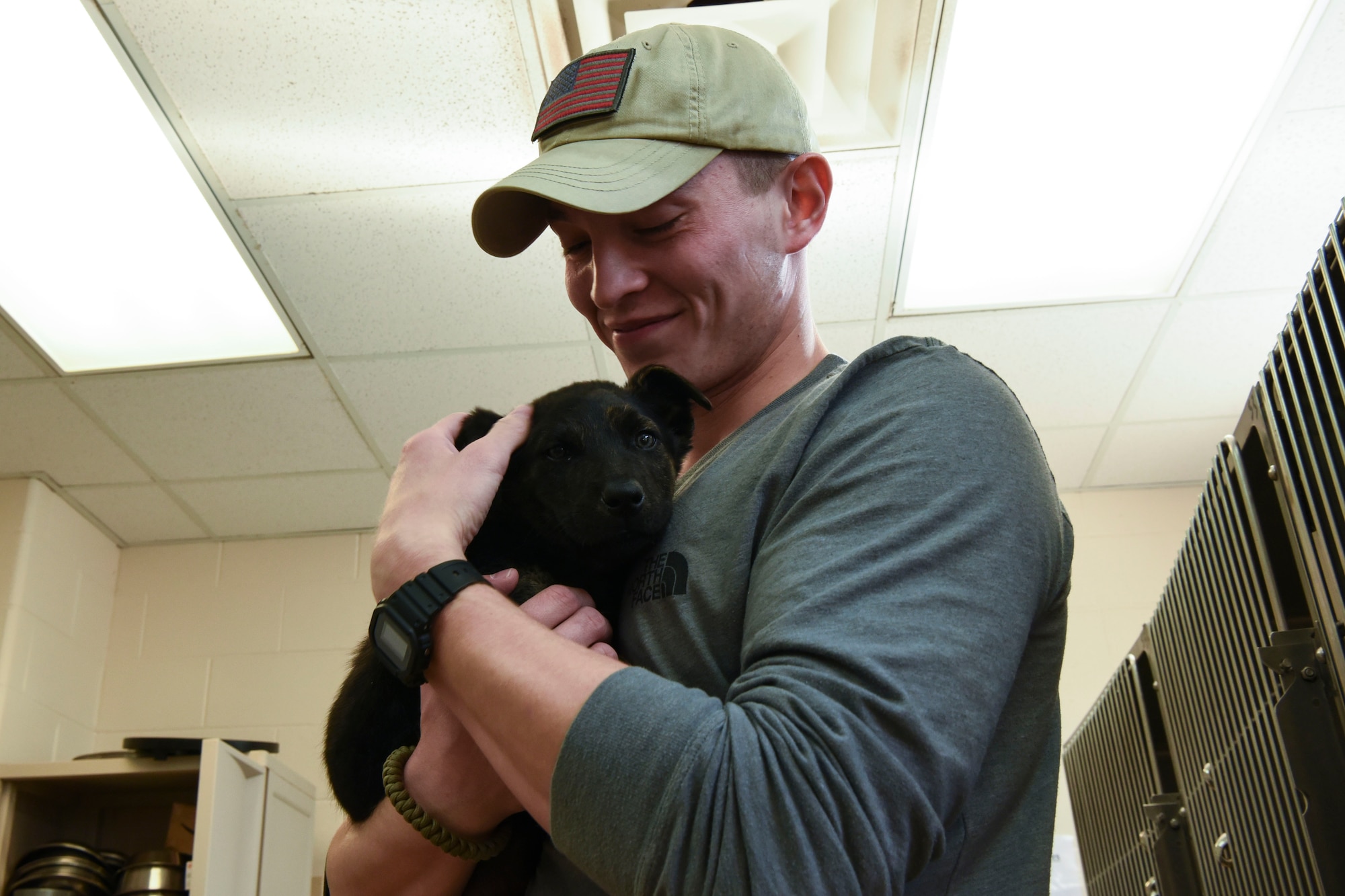 Senior Airman Dylan Schmidt, a 348th Reconnaissance Squadron sensor operator, enjoys some play-time with the animals while volunteering at Circle of Friends Humane Society Sept. 19, 2018, in Grand Forks, North Dakota. The volunteer leads suggested giving the animals attention, so Schmidt played with Bruce, a German Sheppard puppy. (U.S. Air Force photo by Airman 1st Class Melody Wolff)