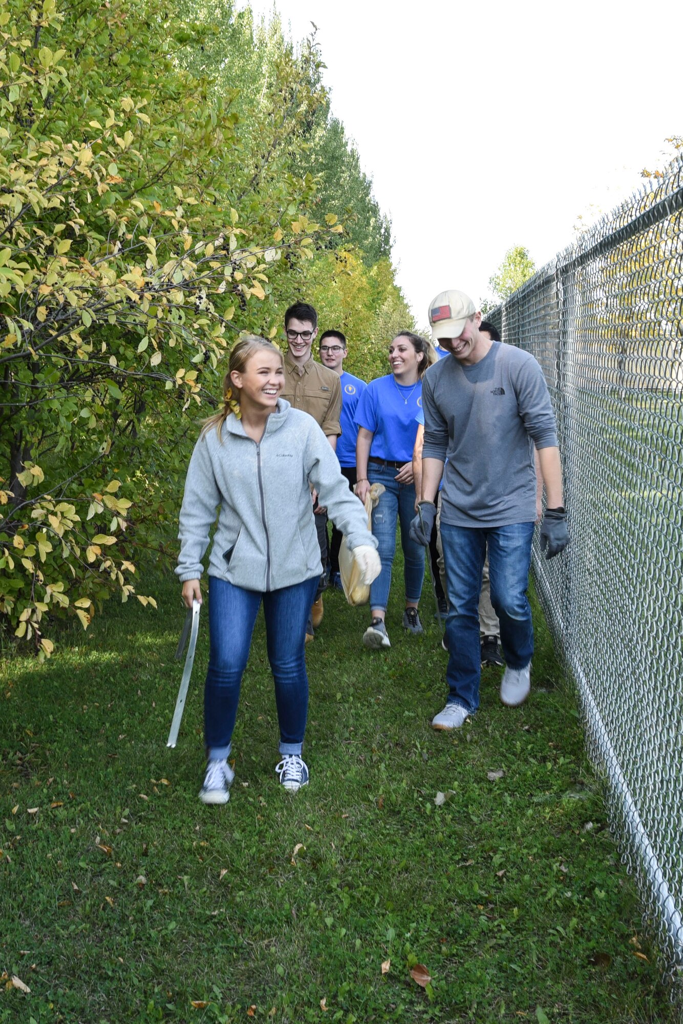 Airmen from the 348th Reconnaissance Squadron help pick up garbage around Circle of Friends Humane Society Sept. 19, 2018, in Grand Forks, North Dakota. The Airmen aided in picking up trash, metal, and other rubbish from the highway by the shelter, to ensure the safety of the animals when they are running around outside. (U.S. Air Force photo by Airman 1st Class Melody Wolff)