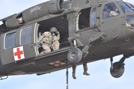 Colorado Army National Guard Sgt. Ryan Osadchuk is captured at work, "Tebowing" aboard a Colorado Army National Guard UH-60 Black Hawk helicopter Jan. 4, 2012. "Tebowing" is to get down on a knee, put your fist to your forehead and start praying, even if everyone else around you is doing something completely different. Osadchuck, a Denver Broncos fan, spontaneously posed in defiance of the photographer, who is a die-hard Pittsburgh Steelers fan; and in admiration of Broncos' starting quarterback Tim Tebow, who is well known for his demonstrations of faith. The Denver Broncos and Pittsburgh Steelers will face off in the 2012 AFC Wild Card game on Jan. 8, 2012. The helicopter and Soldiers represent the 2nd Battalion, 135th General Support Aviation, and are performing sling-load operations. (Photo by Colorado Army National Guard Staff Sgt. Marc Belo/Used with permission)