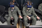 U.S. Air Force Second Lt. Charles Keller and Airman First Class Tyler Haselden, Pilot Training Next students, train on a virtual reality flight simulator at the Armed Forces Reserve Center in Austin, Texas, June 21. Air Education and Training Command officials announced the second iteration of Pilot Training Next would begin in January 2019 during a panel at the 2018 Air Force Association Air, Space and Cyber Conference in National Harbor, Maryland.