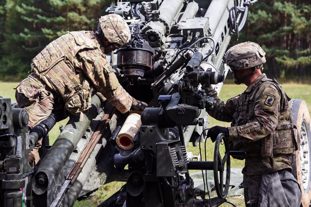 A soldier sets up an M777 howitzer during a live-fire exercise.