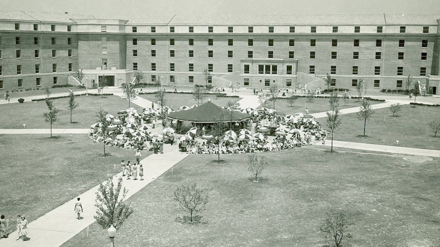 People walk on a walkway in the Pentagon courtyard.