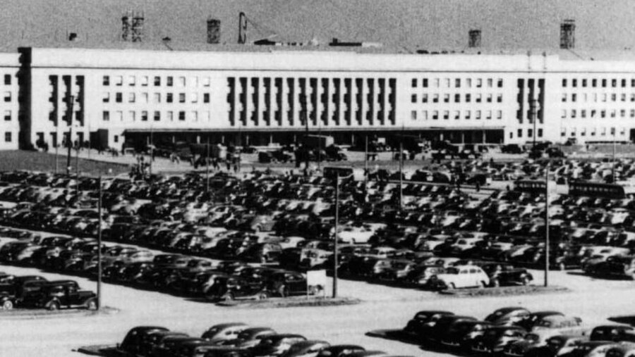 Cars sit parked in rows in a lot outside the Pentagon.