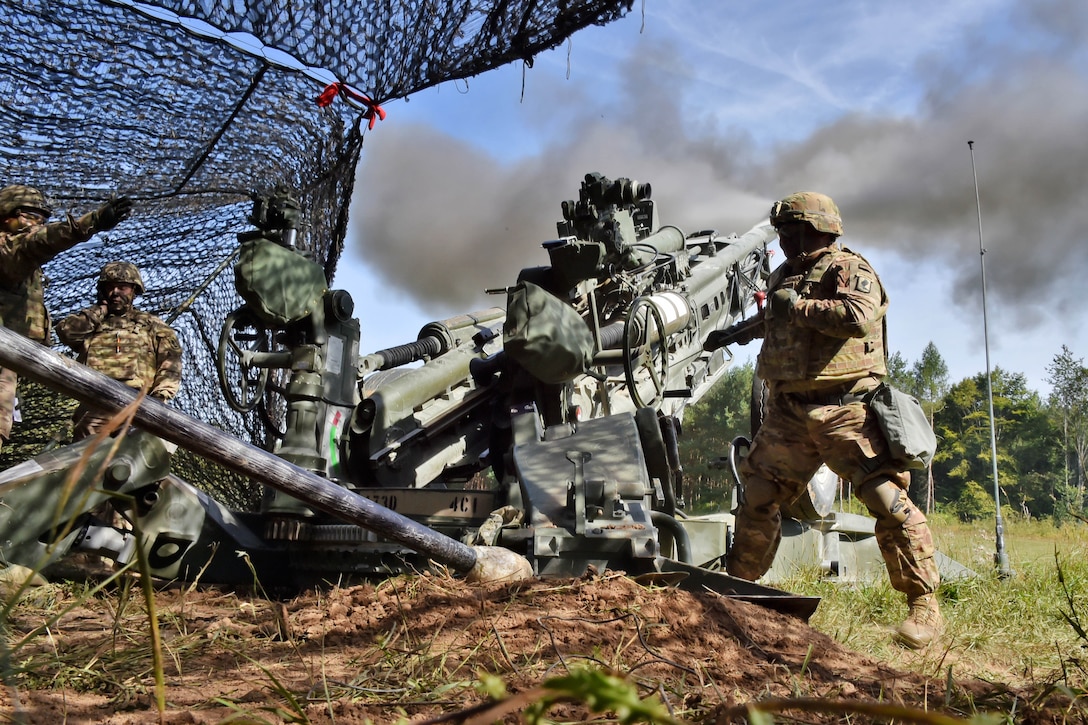 Soldiers fire an M777 howitzer during a live-fire exercise.