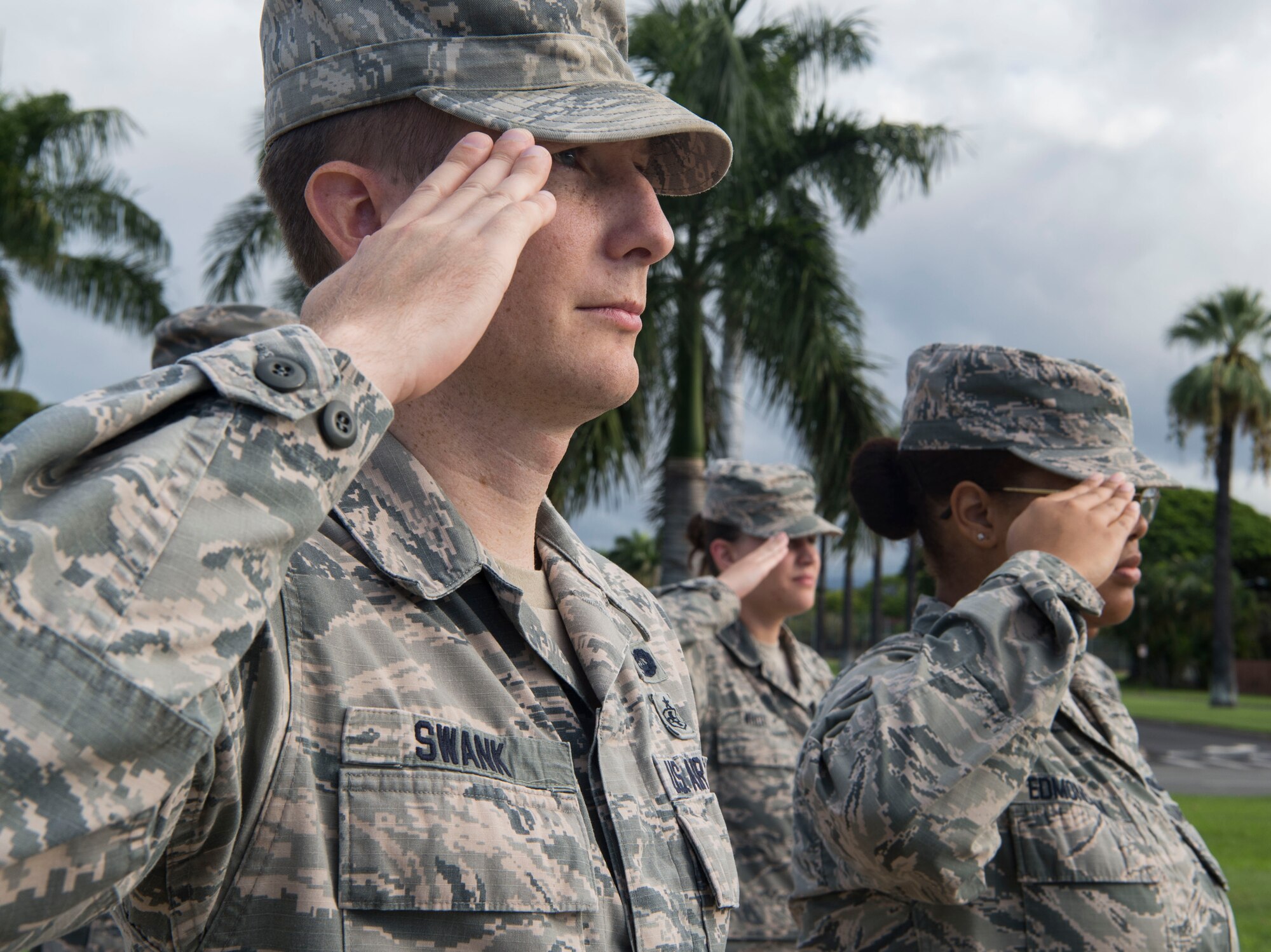 Tech. Sgt. Skylar Swank, 15th Wing general law paralegal, salutes the flag during the Reveille Ceremony for Prisoners of War and Missing in Action Week, Joint Base Pearl Harbor-Hickam, Hawaii, Sept. 17, 2018.  The ceremony kicked off the observances for the weeklong events commemorating those who were prisoners of war or classified as missing in action. The events include readings of the POW/MIA names, a reveille ceremony, beautification of POW/MIA memorial, information tables, sentinel posting, a 24-hour run, and ends on Friday with a POW/MIA Remembrance Ceremony at the National Memorial Cemetery of the Pacific in Honolulu. Observances of National POW/MIA Recognition Day are held across the country on military installations, ships at sea, state capitals, schools and veterans facilities. It is traditionally observed on the third Friday in September each year. (U.S. Air Force photo by Tech. Sgt. Heather Redman)
