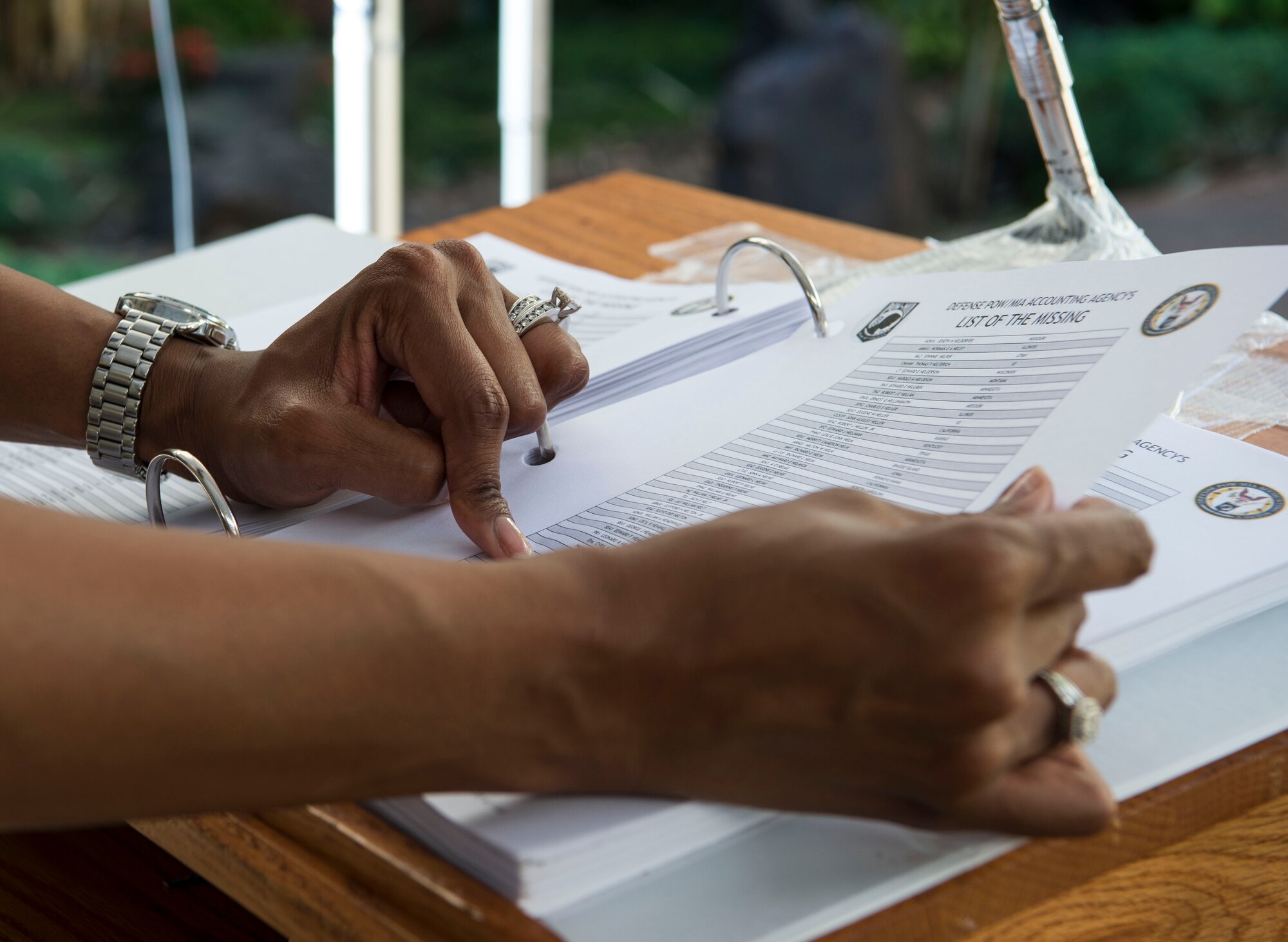 Master Sgt. Angel Jenkins, Transportation Command Patient Movements Requirements Center superintendent, scrolls through a list of prisoners of war and those missing in action, Joint Base Pearl Harbor-Hickam, Hawaii, Sept. 18, 2018.  From Sept. 17-21, volunteers will read the names of those who were classified as missing or unaccounted for as part of POW/MIA Recognition Week. Over 80,000 Americans still remain missing or unaccounted for from World War II, the Korean War, the Vietnam War, and the Cold War.  (U.S. Air Force photo by Tech. Sgt. Heather Redman)
