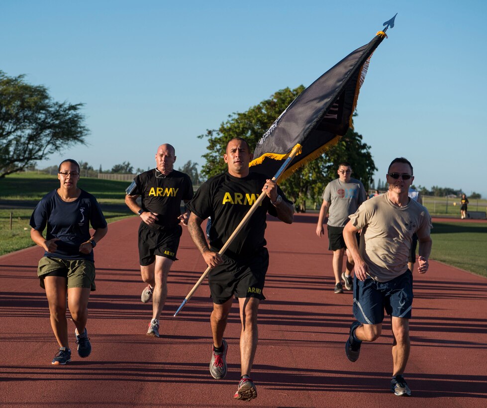 Members from the Defense POW/MIA Accounting Agency kick off the 24-hour run for Prisoners of War and Missing in Action Week, Joint Base Pearl Harbor-Hickam, Hawaii, Sept. 20, 2018.  Throughout the day participants will take shifts running around the Hickam Field track in remembrance of America's prisoners of war, those who are still missing in action and their families. From Sept. 17-21, events will be held throughout JBPHH as part of POW/MIA Recognition Week. The events include readings of the POW/MIA names, a reveille ceremony, beautification of POW/MIA memorial, information tables, sentinel posting, a 24-hour run, and ends on Friday with a POW/MIA Remembrance Ceremony at the National Memorial Cemetery of the Pacific in Honolulu. Observances of National POW/MIA Recognition Day are held across the country on military installations, ships at sea, state capitals, schools and veterans facilities. It is traditionally observed on the third Friday in September each year. (U.S. Air Force photo by Tech. Sgt. Heather Redman)