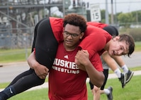 ST. CLOUD, Minn. -- The Marine Corps Officer Selection Team from Fargo, North Dakota, pushes the St. Cloud State University Wrestling team through a Leadership and Cohesion Exercise designed to test their physical and mental strength, as well as their ability to work as team, in St. Cloud, M.N., Sept. 18, 2018. At the end of the exercises, the Marines lead the team through a discussion about their core values; honor, courage and commitment, and how the athletes can apply those values to what they do as wrestlers, but also as students and ambassadors for the university.