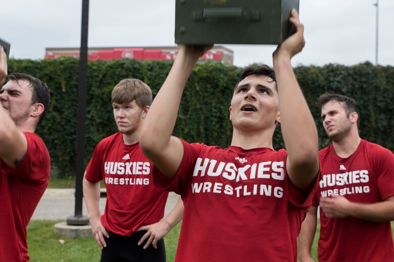 ST. CLOUD, Minn. -- The Marine Corps Officer Selection Team from Fargo, North Dakota, pushes the St. Cloud State University Wrestling team through a Leadership and Cohesion Exercise designed to test their physical and mental strength, as well as their ability to work as team, in St. Cloud, M.N., Sept. 18, 2018. At the end of the exercises, the Marines lead the team through a discussion about their core values; honor, courage and commitment, and how the athletes can apply those values to what they do as wrestlers, but also as students and ambassadors for the university.