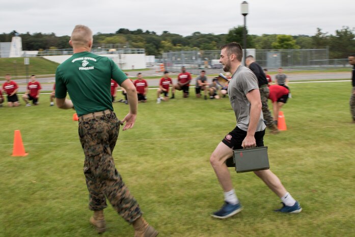 ST. CLOUD, Minn. -- The Marine Corps Officer Selection Team from Fargo, North Dakota, pushes the St. Cloud State University Wrestling team through a Leadership and Cohesion Exercise designed to test their physical and mental strength, as well as their ability to work as team, in St. Cloud, M.N., Sept. 18, 2018. At the end of the exercises, the Marines lead the team through a discussion about their core values; honor, courage and commitment, and how the athletes can apply those values to what they do as wrestlers, but also as students and ambassadors for the university.