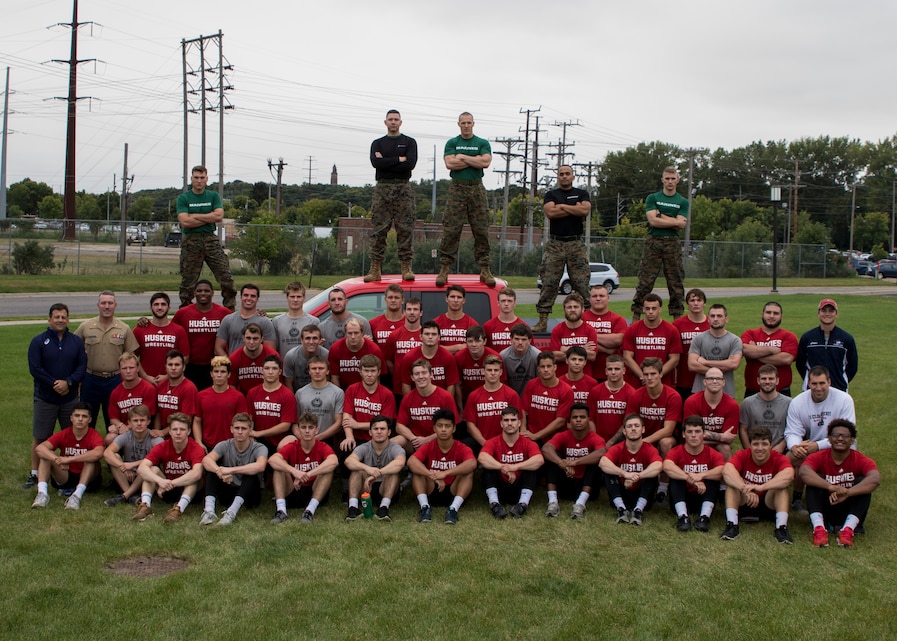 ST. CLOUD, Minn. -- The Marine Corps Officer Selection Team from Fargo, North Dakota, pushes the St. Cloud State University Wrestling team through a Leadership and Cohesion Exercise designed to test their physical and mental strength, as well as their ability to work as team, in St. Cloud, M.N., Sept. 18, 2018. At the end of the exercises, the Marines lead the team through a discussion about their core values; honor, courage and commitment, and how the athletes can apply those values to what they do as wrestlers, but also as students and ambassadors for the university.