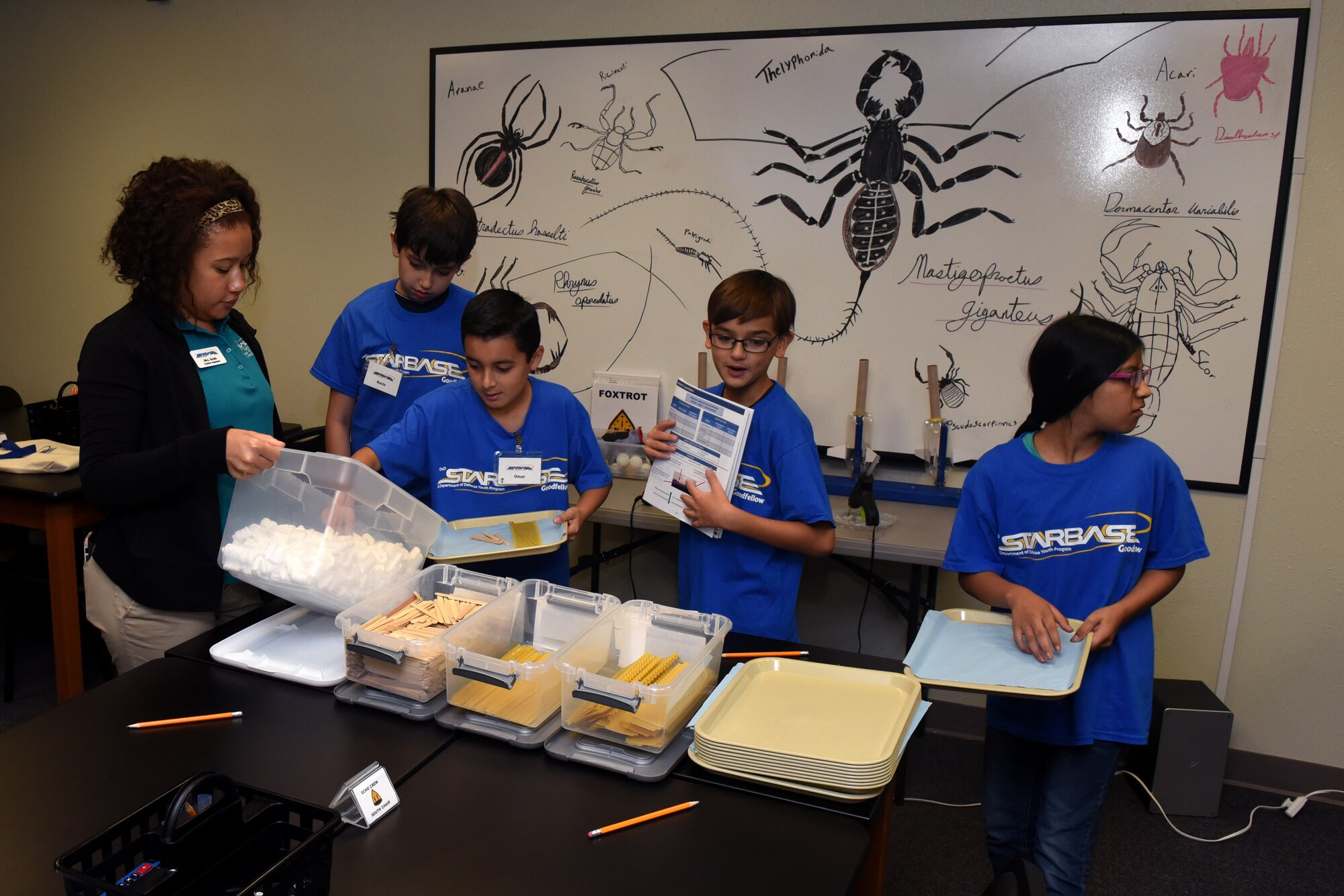 Children gather material to build a lasagna bridge, to learn about buoyancy, while attending STARBASE at Goodfellow Air Force Base, Texas, Sept 7, 2018. The students learned about buoyancy by creating a bridge with only marshmallows, popsicle sticks and lasagna, this gave a hands-on demonstration about weight distribution. (U.S. Air Force photo by Airman 1st Class Zachary Chapman/Released)