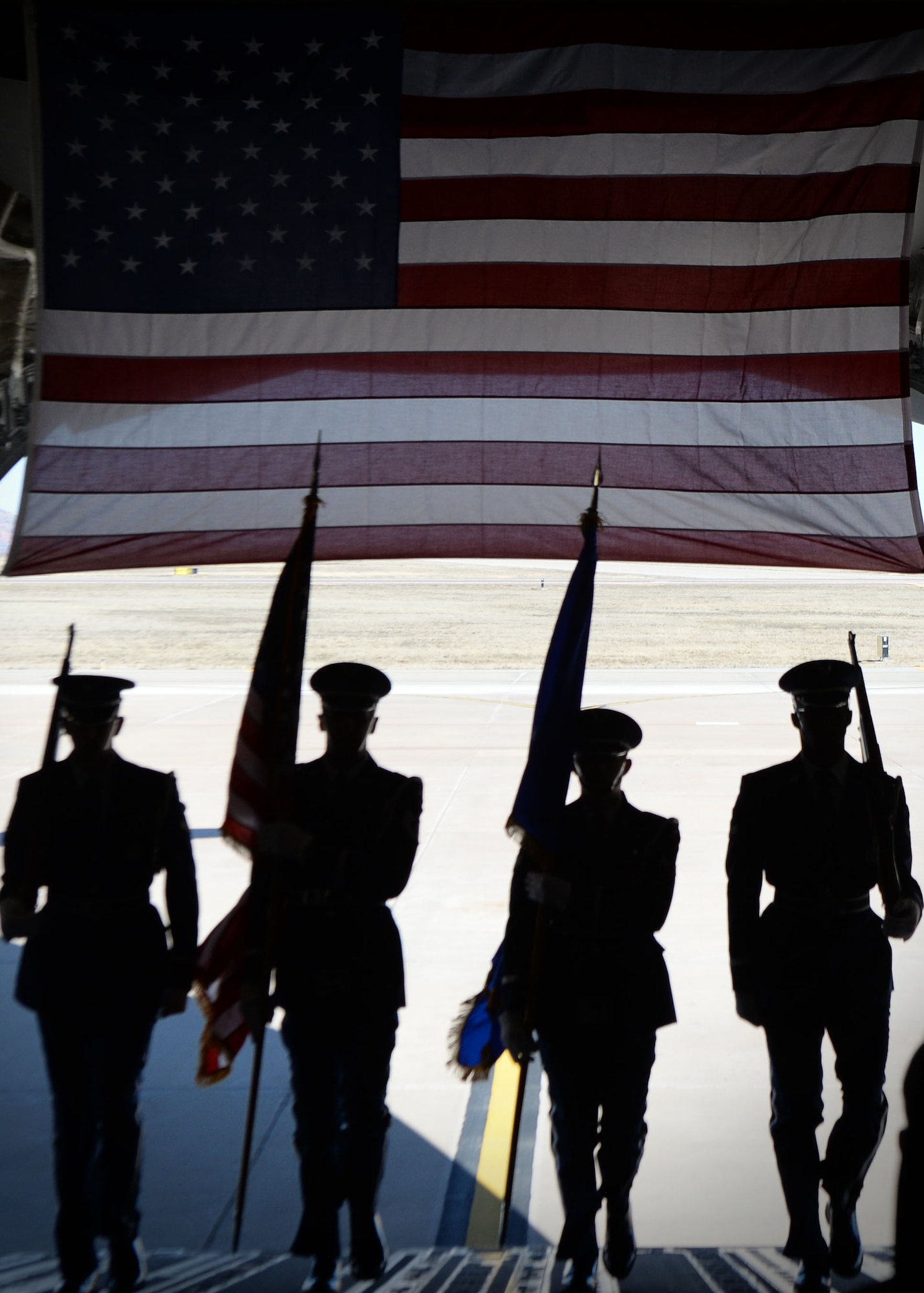 U.S. Air Force Honor Guard members carry flags up the ramp of a C-17 for a retirement ceremony March 5, 2018, Altus Air Force Base, Okla. Honor Guard members perform in ceremonies in order to honor both Air Force heritage and fallen service members. (U.S. Air Force photo by Airman 1st Class Jeremy Wentworth)