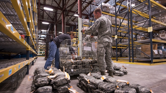 Jessica Parker, 92nd Logistics Readiness Squadron Individual Protective Equipment supply technician supervisor (left), Airman Diego Najera-Dominguez, 92nd LRS IPE apprentice, and Staff Sgt. Jeffery Jones, 92nd LRS IPE supervisor, sort through Joint First Aid Kit packages Sept. 19, 2018, at Fairchild Air Force Base, Washington. IPE gear is cleaned, inspected and returned to storage each and every time it is issued to help ensure the safe functionality of items such as armor, gas masks and weapons. (U.S. Air Force photo/Senior Airman Ryan Lackey)