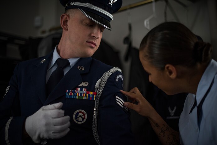 Senior Airman Philip Spegal and Airman 1st Class Ashley Libbey, Nellis Air Force Base honor guardsmen, perform last-minute uniform inspections at the Southern Nevada Veterans Memorial Cemetery, Sept. 14, 2018. The mission of the Nellis Honor Guard is to represent the Air Force in a variety of ceremonial functions in Southern Nevada, California, Arizona and Utah. (U.S. Air Force photo by Airman 1st Class Andrew D. Sarver)