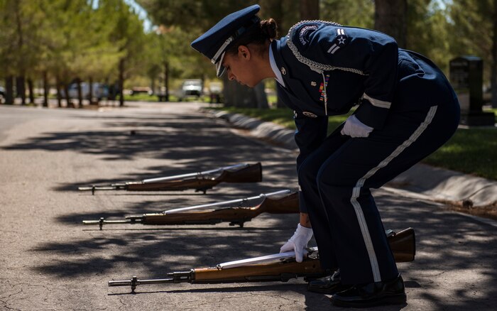 A1C Ashely Libbey, Nellis Air Force Base honor guardsman, aligns rifles during a military honors funeral at the Southern Nevada Veterans Memorial Cemetery, Sept. 14, 2018. Before any guardsman is put on a detail, they have nearly a month of training to learn the basic movements. Afterwards, they continue to meticulously work out the slightest imperfections. (U.S. Air Force photo by Airman 1st Class Andrew D. Sarver)
