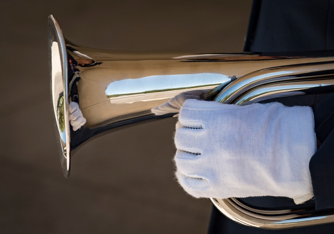 Airman 1st Class MaryJane Gutierrez, Nellis Air Force Base honor guardsman, salutes during after playing taps during a military honors funeral at the Southern Nevada Veterans Memorial Cemetery, Sept. 14, 2018. Honor guardsmen are responsible for rendering military honors for funeral services and various Air Force ceremonies as well as provide their services at various opening ceremonies. (U.S. Air Force photo by Airman 1st Class Andrew D. Sarver)