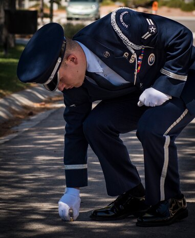Airman 1st Class Sean Beanblossom, Nellis Air Force Base honor guardsman, retrieves brass shell casings after a military honors funeral to present to the family at the Southern Nevada Veterans Memorial Cemetery, Sept. 14, 2018. Military honors funerals are just one of many details the team performs. (U.S. Air Force photo by Airman 1st Class Andrew D. Sarver)
