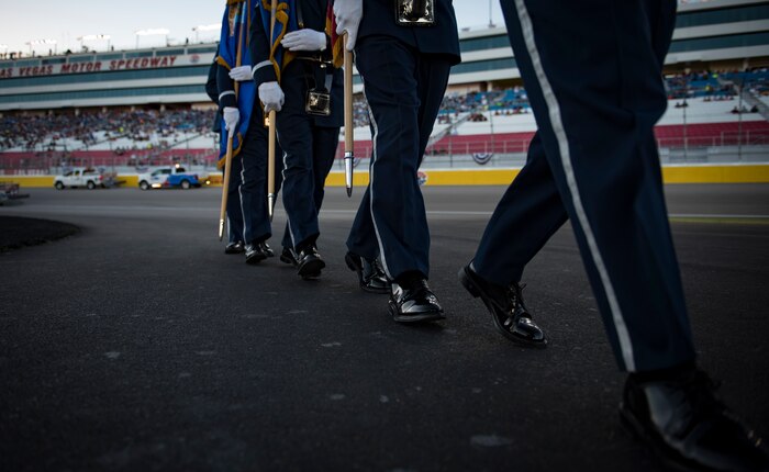 Nellis Honor Guardsmen march in formation after presenting the colors at the South Point 400 NASCAR race opening ceremonies at the Las Vegas Motor Speedway, Sept. 14, 2018. Presenting the colors is one of many details the team performs. (U.S. Air Force photo by Airman 1st Class Andrew D. Sarver)