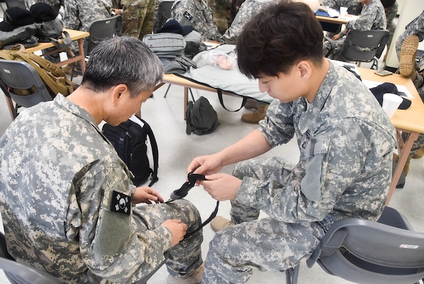 U.S. Army Corps of Engineers, Far East District, Emergency Essential Civilian (EEC) personnel practice first-aid techniques during the district's EEC training held at the Vehicle Maintenance Facility, Aug. 22.