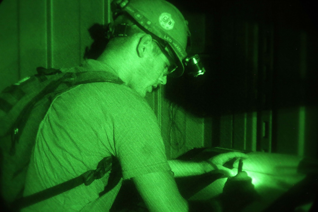 A sailor updates dispatch information while conducting a water well exploration operation.
