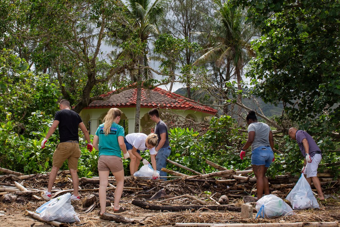 U.S. Marines and sailors with  Marine Aircraft Group (MAG) 12, pick up trash during Exercise Valiant Shield 18 at Agat beach, Guam, Sep. 17, 2018. Valiant Shield is a biennial, U.S. only, field training exercise (FTX) with a focus on integration of joint training among U.S. forces in relation to current operational plans. This training enables real-world proficiency in sustaining joint forces through detecting, locating, tracking and engaging units at sea, in the air, on land, and in cyberspace in response to a range of mission areas.