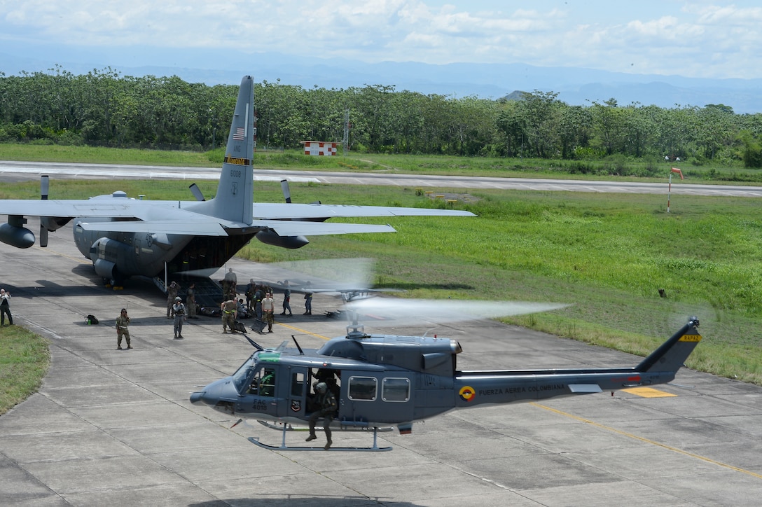 Colombian Air Force Tech. Sgt. Manuel Molina Garzon, sets up a radio to communicate with rescue helicopters rescue teams at Air Combat Command number 1, German Olano Air Base, Colombia, for the Colombian-led search and rescue exercise Angel de los Andes Sept. 6, 2018.