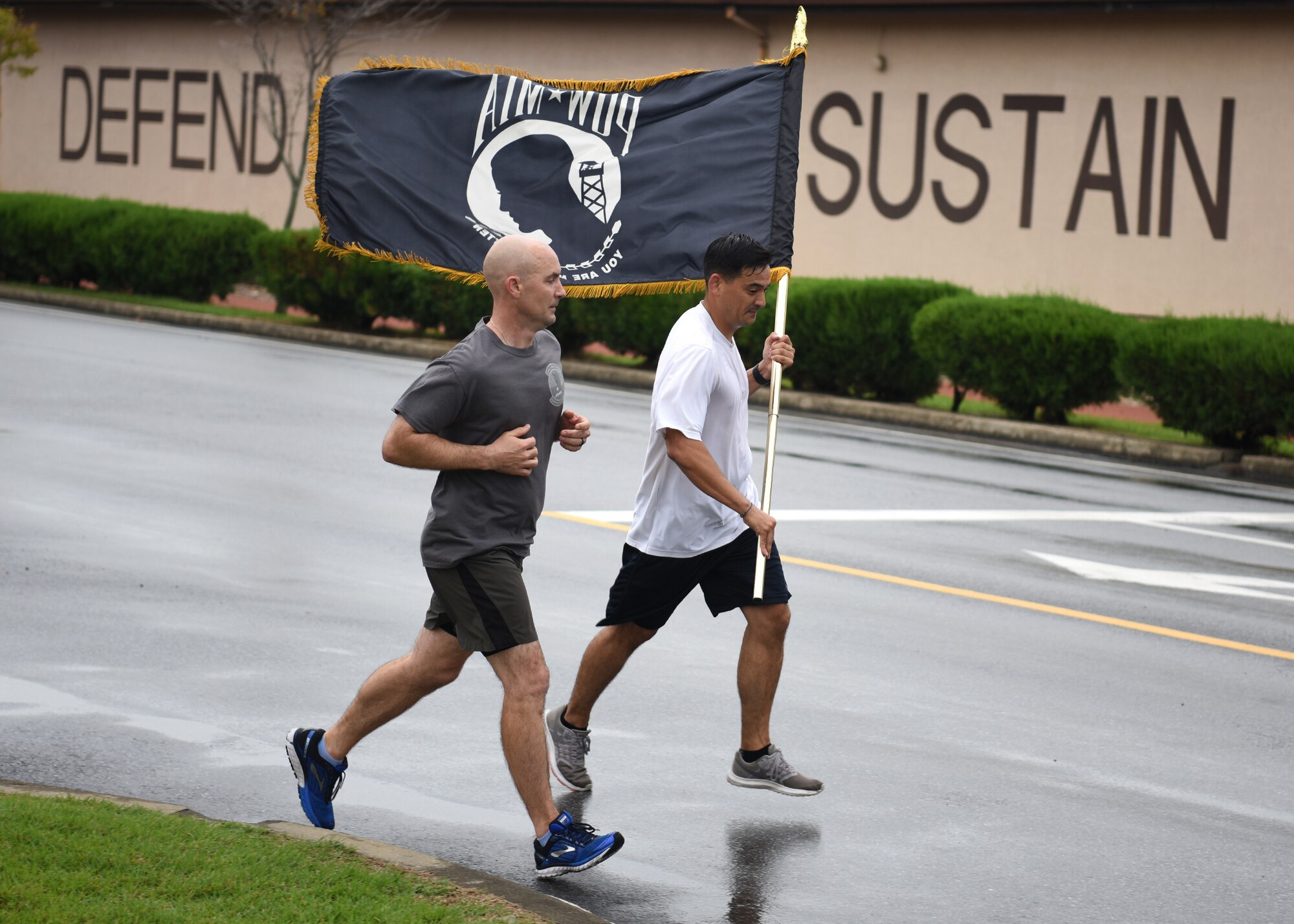 U.S. Air Force Tech. Sgt. Kurt Kanzler, a precision guidance munitions production supervisor with the 51st Munitions Squadron, runs with a prisoner of war and missing in action flag during a 24-hour vigil run at Osan Air Base, Republic of Korea, Sept. 21, 2018. The main purpose of POW/MIA Remembrance Day is to pay tribute and honor the sacrifices of prisoners of war and those who are missing in action. (U.S. Air Force photo by Staff Sgt. Sergio A. Gamboa)