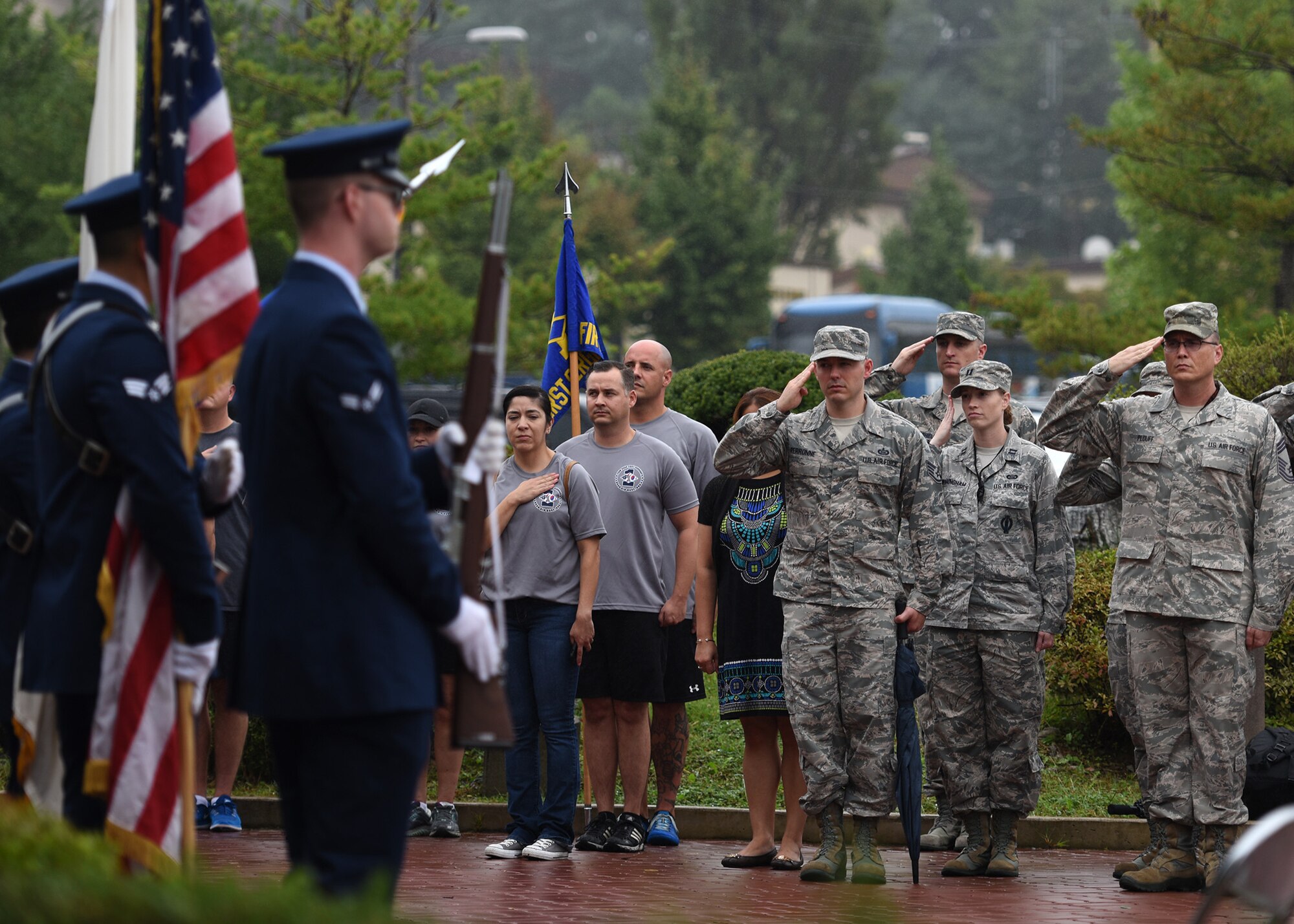 Team Osan members salute the U.S. Flag during the playing of the U.S. National Anthem during a prisoner of war and missing in action remembrance ceremony at Osan Air Base, Republic of Korea, Sept. 20, 2018. National POW/MIA Recognition Day is observed the third Friday in September yearly. (U.S. Air Force photo by Staff Sgt. Sergio A. Gamboa)