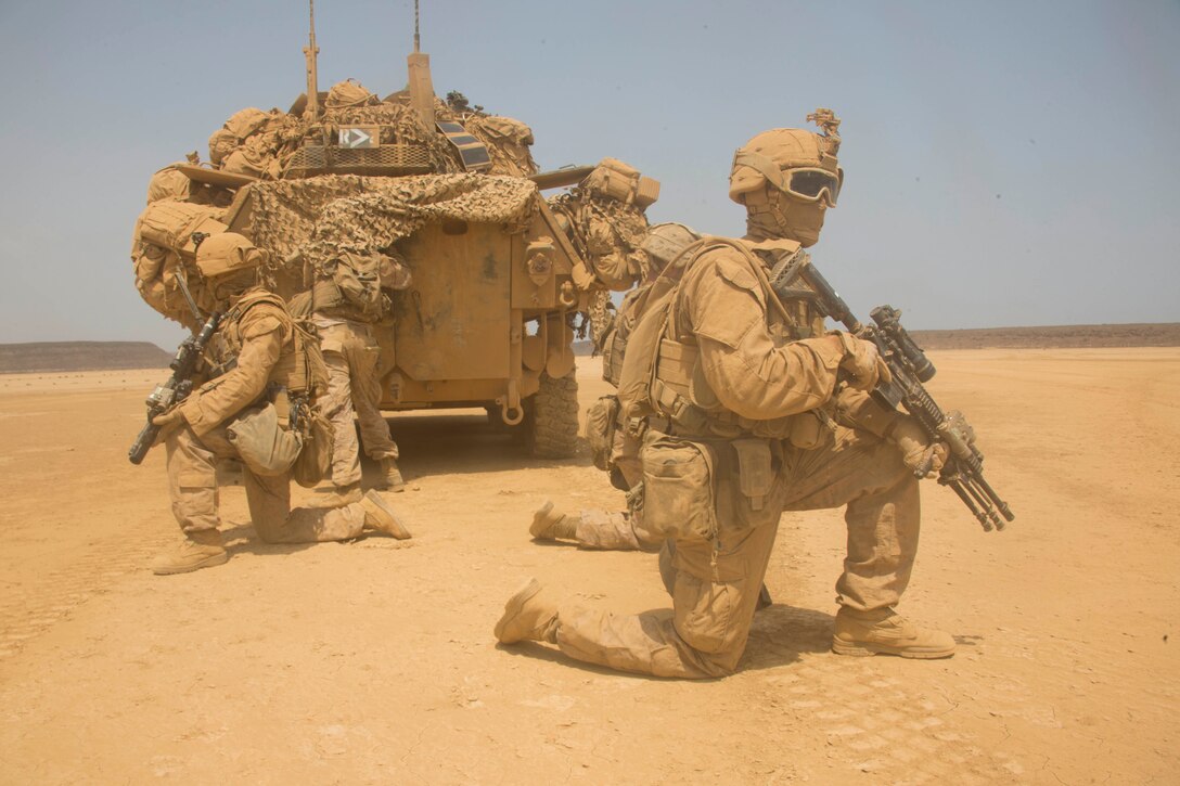 Marines assigned to red platoon of the Light Armored Reconnaissance Company of Battalion Landing Team 3/1, 13th Marine Expeditionary Unit, set up security boundaries outside of their vehicle during Theater Amphibious Combat Rehearsal (TACR) 18.