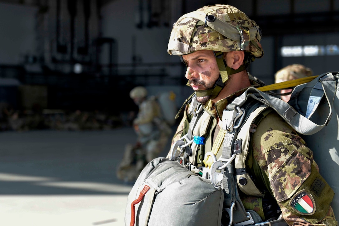 An Italian soldier carries his gear to board a C-17 Globemaster III as part of Exercise Saber Junction 18 at Ramstein Air Base, Germany, Sept. 19, 2018. Air Force photo by Senior Airman Alexis Schultz