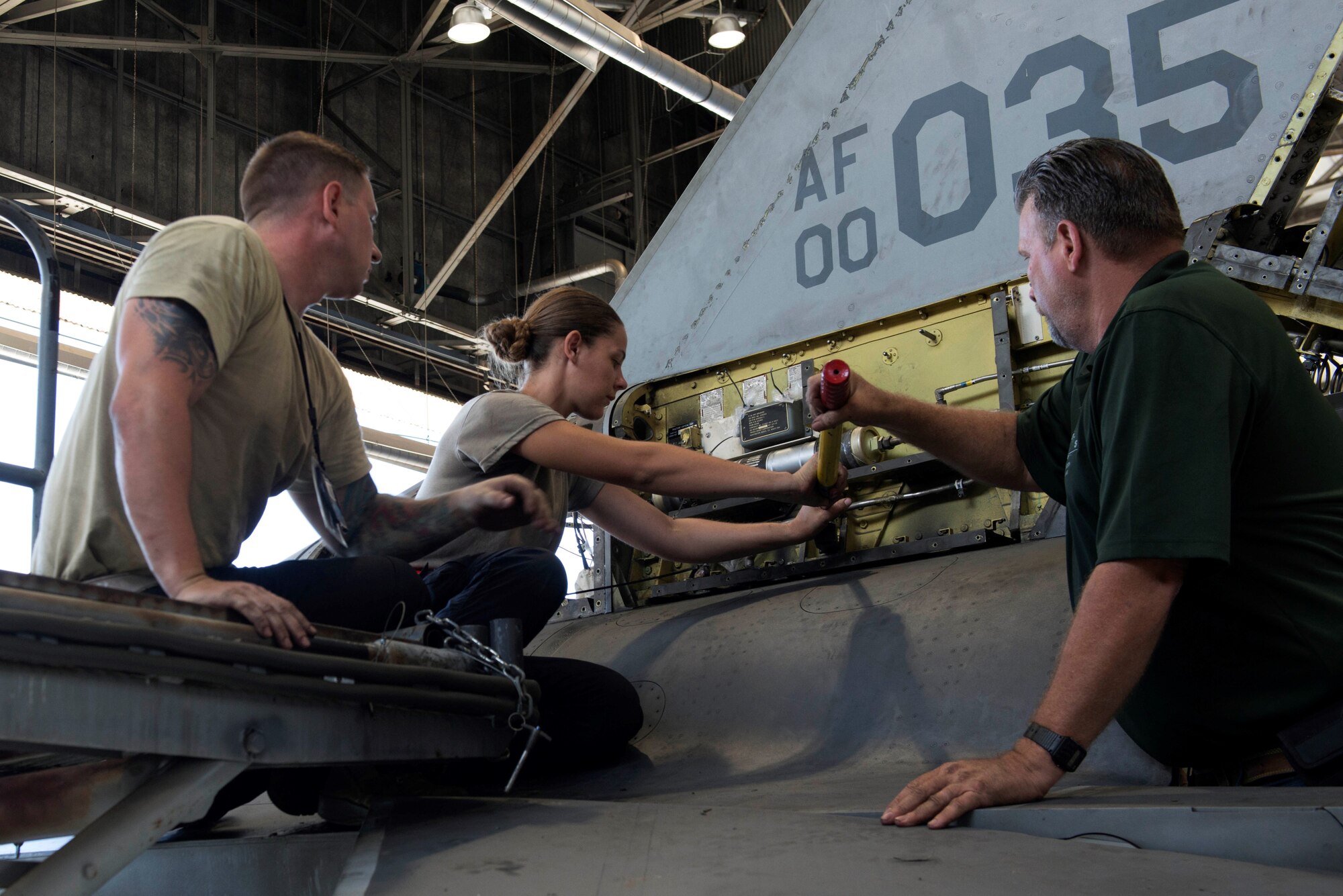 U.S. Air Force Staff Sgt. Ronald Scala, 20th Aircraft Maintenance Squadron (AMXS) tactical aircraft maintainer, left, and Airman 1st Class Krystin Bartelt, 20th AMXS assistant tactical aircraft maintainer, turn a bolt at Shaw Air Force Base, S.C., Sept. 11, 2018.